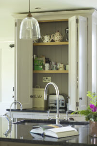 Compact larder cupboard with folding doors