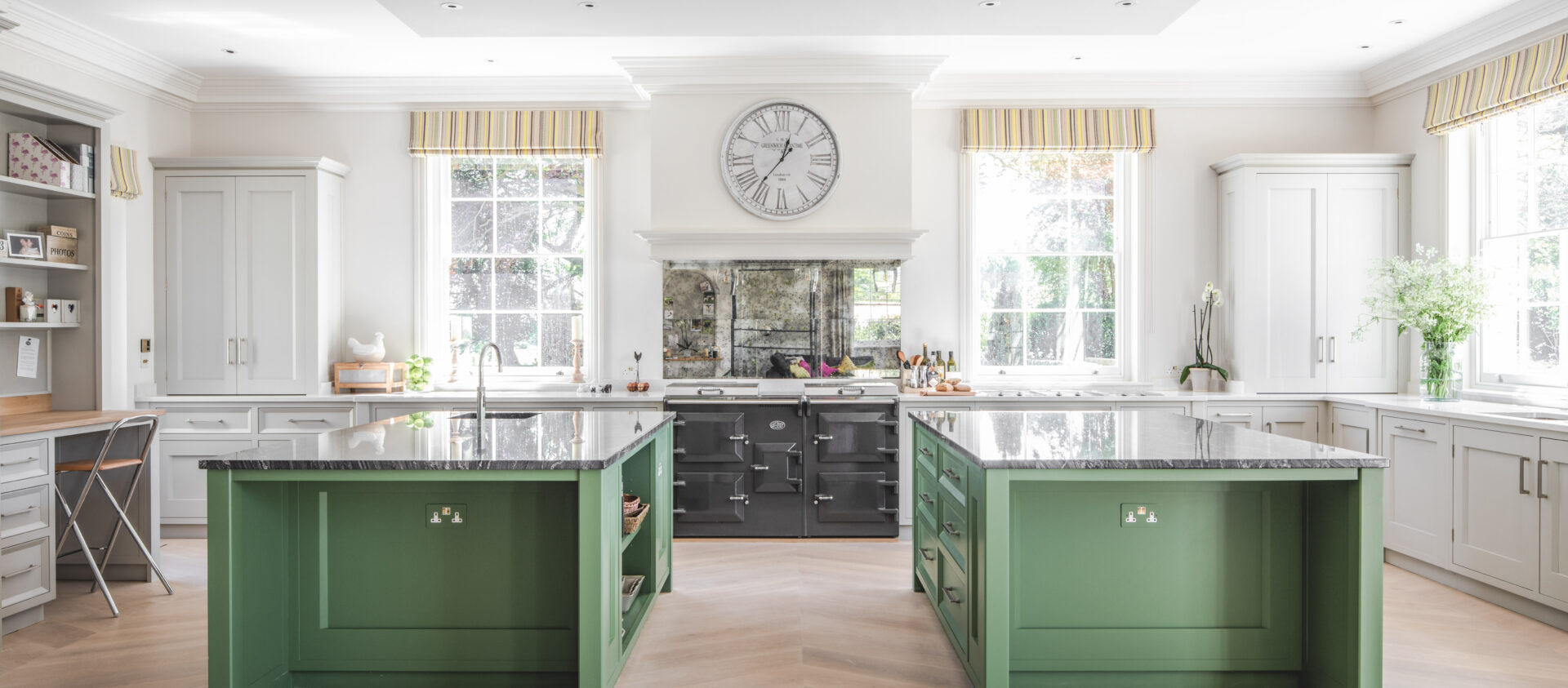 Two large green kitchen islands in a wiltshire house