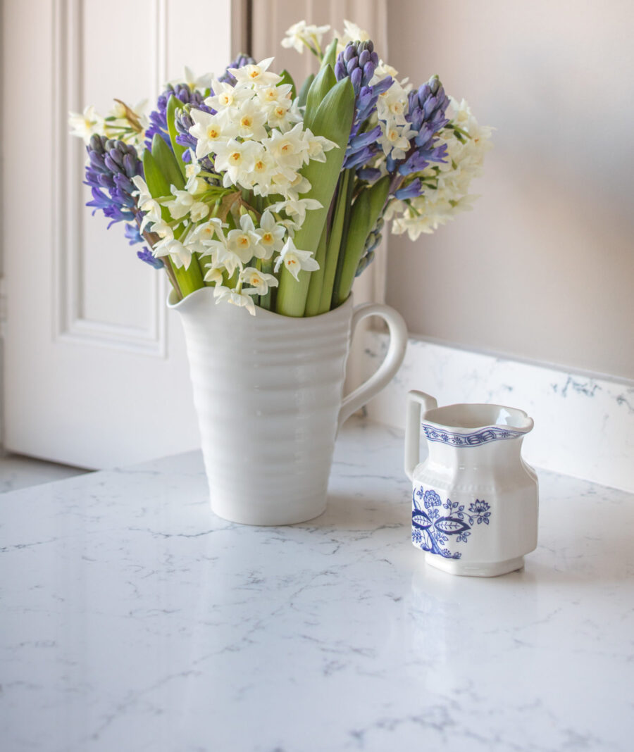 Marble worktop with a jug of Spring flowers Marble worktop with a jug of Spring flowers