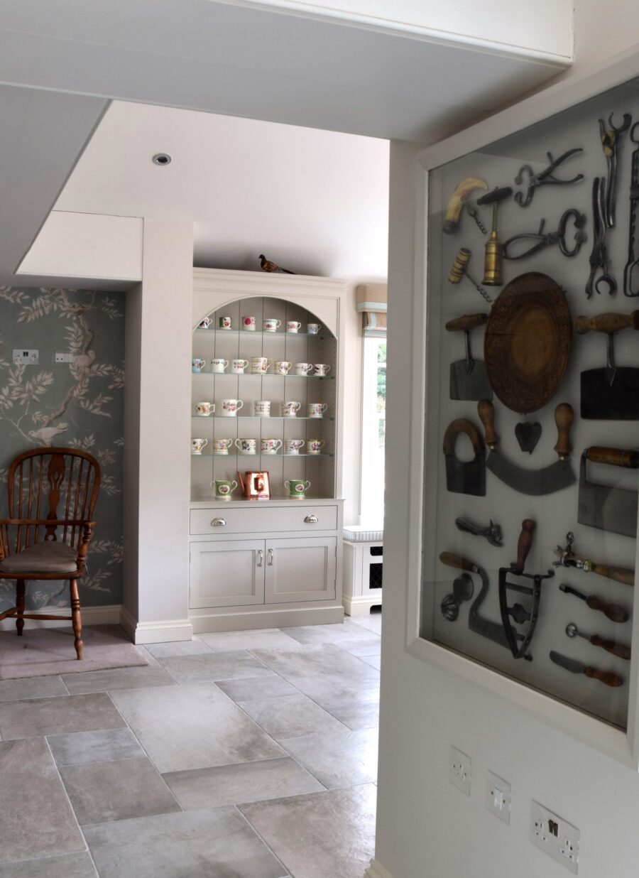 Mary is an avid collector of mugs, sitting hens and old-fashioned kitchen utensils; Nick incorporated a large feature wall frame to house these charming objects. Mary is an avid collector of mugs, sitting hens and old-fashioned kitchen utensils; Nick incorporated a large feature wall frame to house these charming objects.