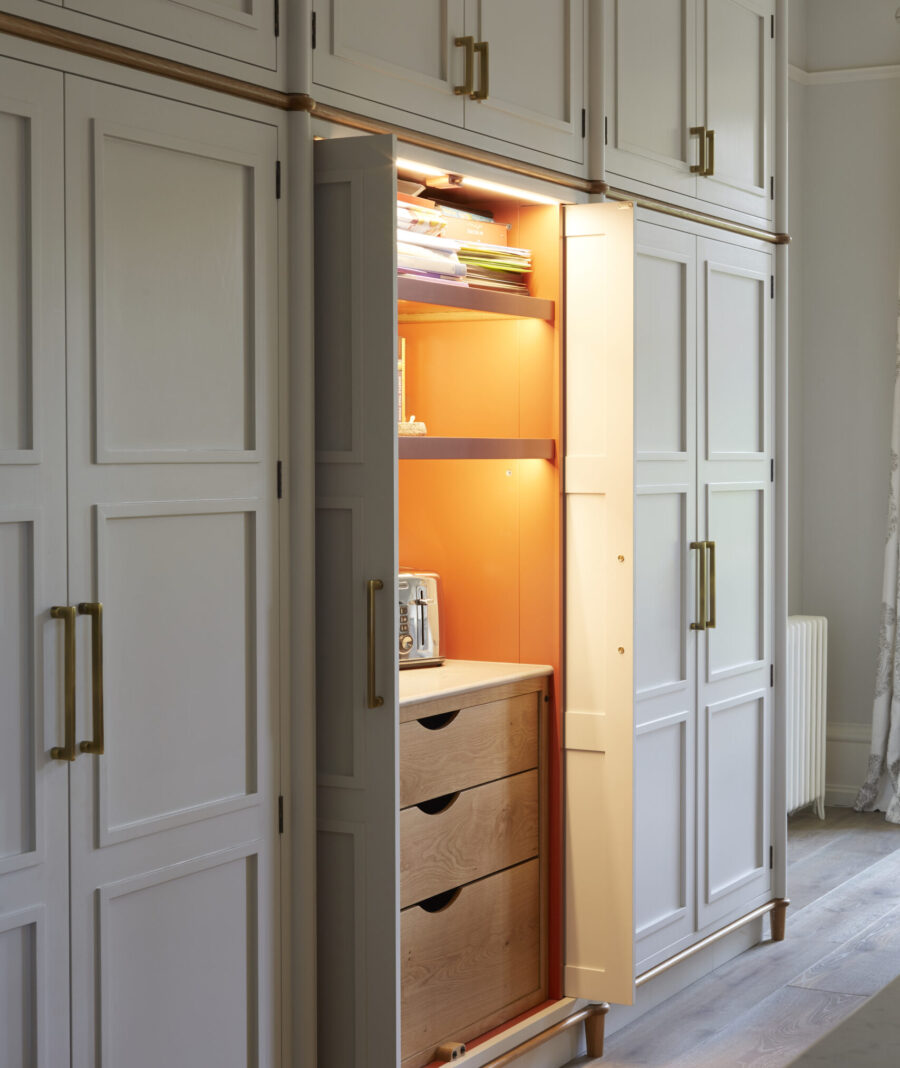A tall bespoke kitchen cabinet with pocket doors A tall bespoke kitchen cabinet with pocket doors