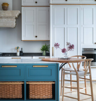 This seating area at the end of a bespoke kitchen island offer relaxed seating alongside useful storage