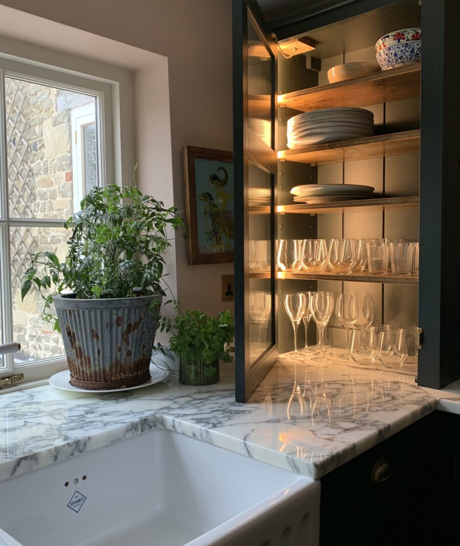 A bespoke reeded glass counter top cabinet with internal LED lighting A bespoke reeded glass counter top cabinet with internal LED lighting