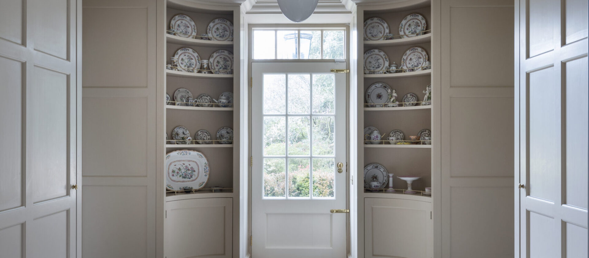 Classically proportioned tall hand painted cabinets designed by Guild Anderson for Trewithen 