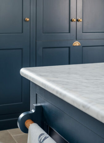 Blue painted kitchen island with marble worksurface