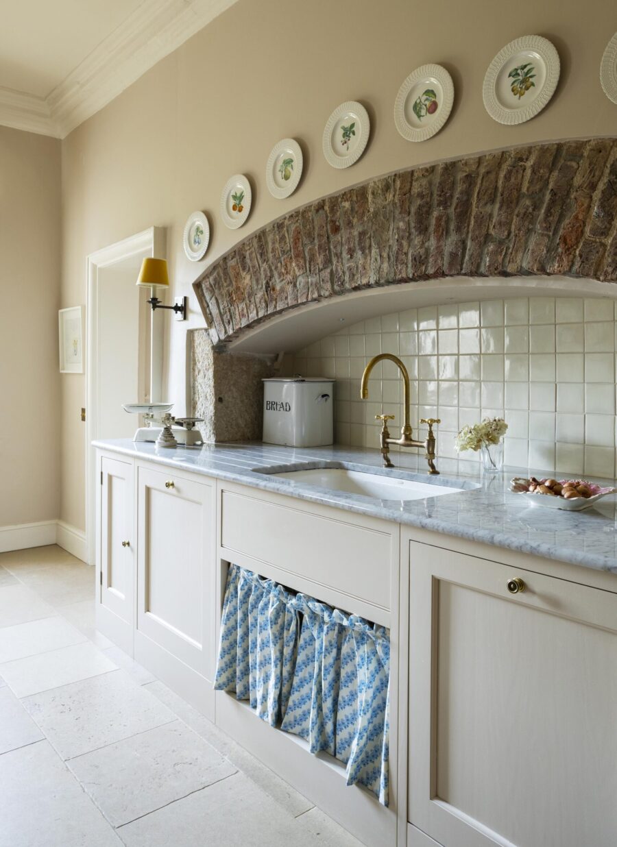 An existing arched fireplace has been used to house a second kitchen sink  An existing arched fireplace has been used to house a second kitchen sink