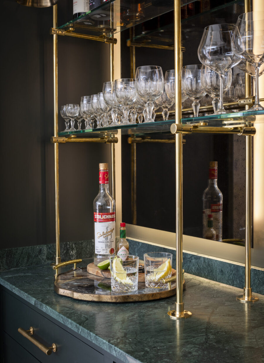 Bespoke brass metal framework supports glass display shelves Bespoke brass metal framework supports glass display shelves