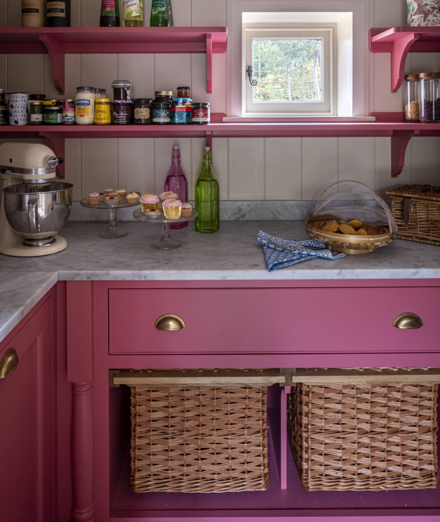 A bright pink hand painted walk-in pantry A bright pink hand painted walk-in pantry