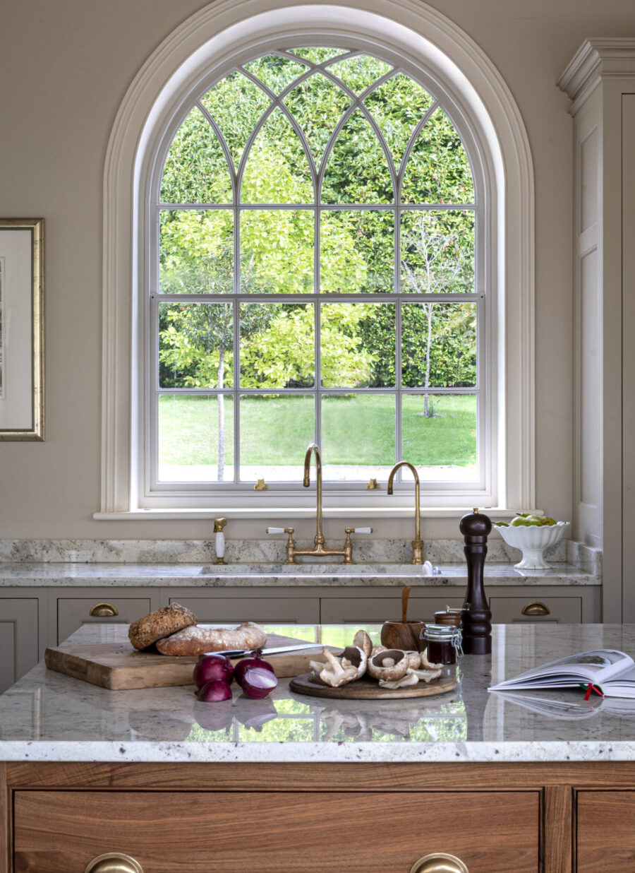 A period arched window sits above the Butlers sink in this Georgian Dorset country house kitchen A period arched window sits above the Butlers sink in this Georgian Dorset country house kitchen