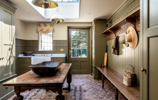 A bespoke bootroom design in a Wiltshire country house in olive green