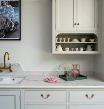 Traditional style wall cupboard designs have been adapted to incorporate small open shelves below to house our clients Susie Watson pottery collection