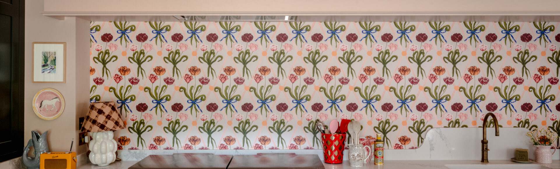 A burgundy Everhot range cooker with Polly Fern wallpaper
