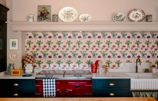 A burgundy Everhot range cooker with Polly Fern wallpaper
