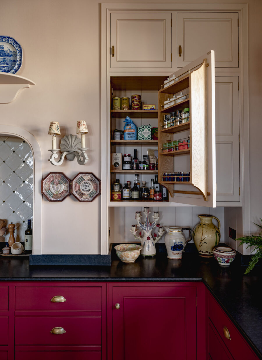 A recessed wall cupboard acts as a small kitchen larder cupboard