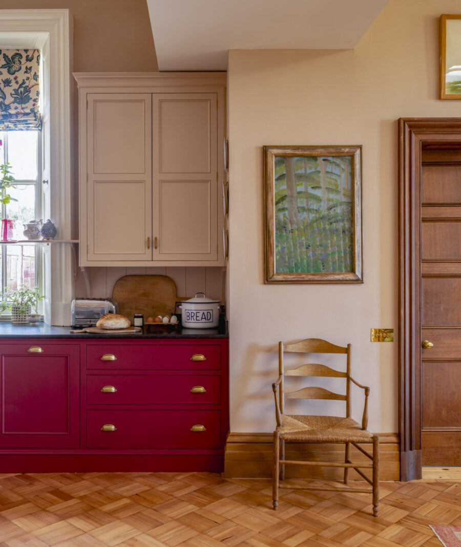 A wall cabinet is supported on brackets, connecting it to the base cabinets below