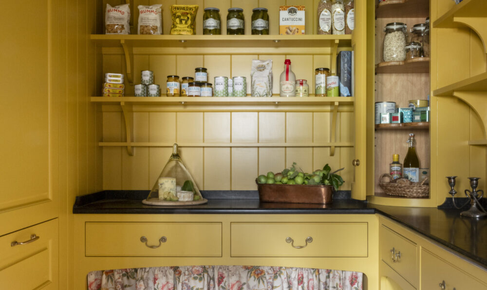 Yellow walk in pantry with curved corner cabinet