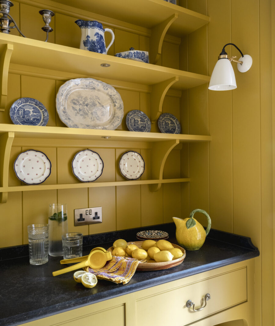 Open shelves in a yellow walk-in pantry