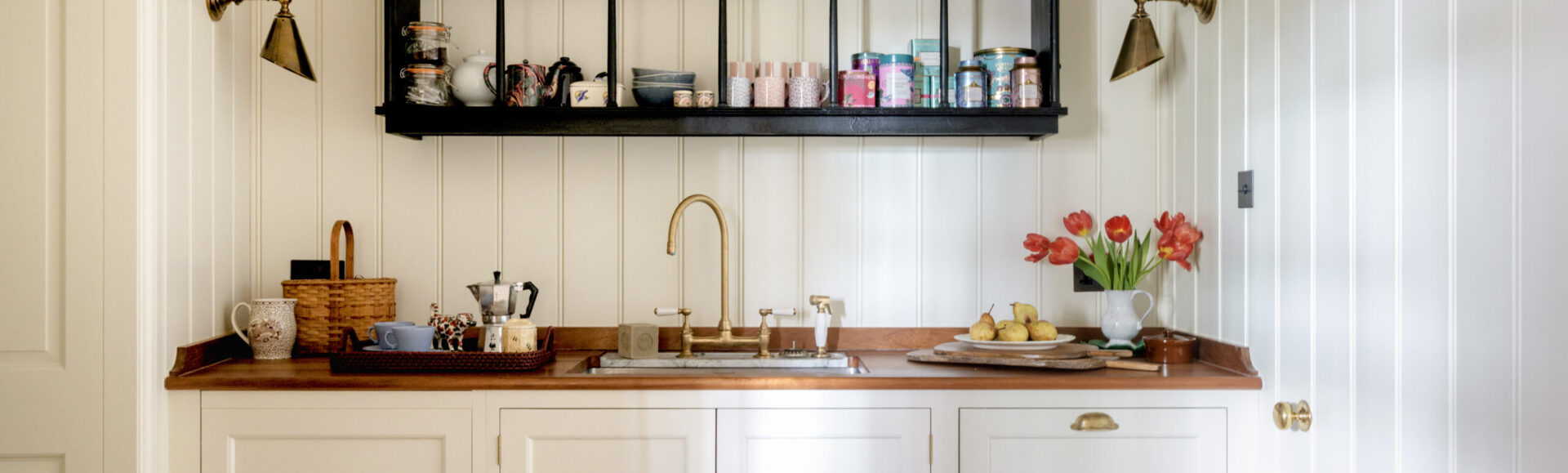 painted panelled pantry design with open wall shelves