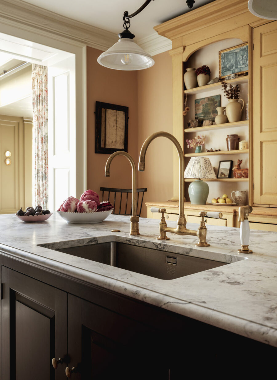 A under counter sink in a hand painted kitchen island with brass tap A under counter sink in a hand painted kitchen island with brass tap