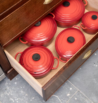 Deep pan drawers sit within the large country farmhouse kitchen island