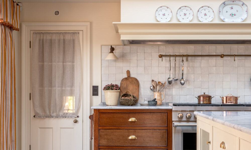 A period farmhouse kitchen design with oak drawers, range cooker and kitchen island