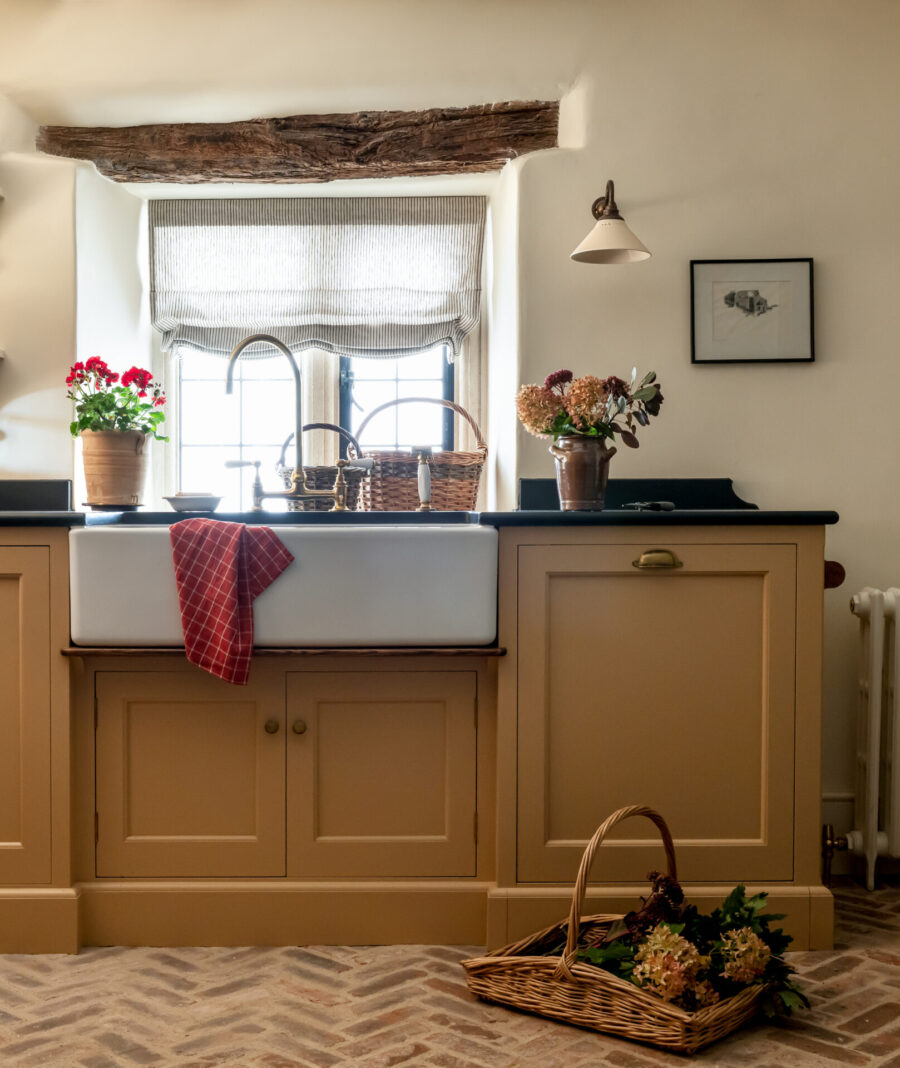 Yellow hand painted cabinets in a scullery which doubles as a boot room Yellow hand painted cabinets in a scullery which doubles as a boot room