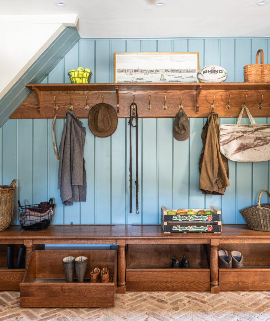 Boot Room Cabinetry storage with open shelves, hooks a bench and bench drawers with a blue panelled wall Boot Room Cabinetry storage with open shelves, hooks a bench and bench drawers with a blue panelled wall