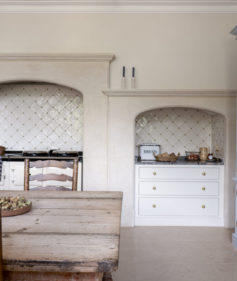 An original stonework mantle has been incorporated it in to the new bespoke kitchen