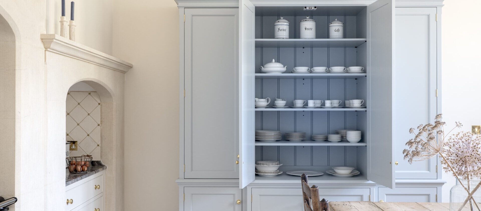 Somerset kitchen design with a blue hand painted housekeeper's cupboard