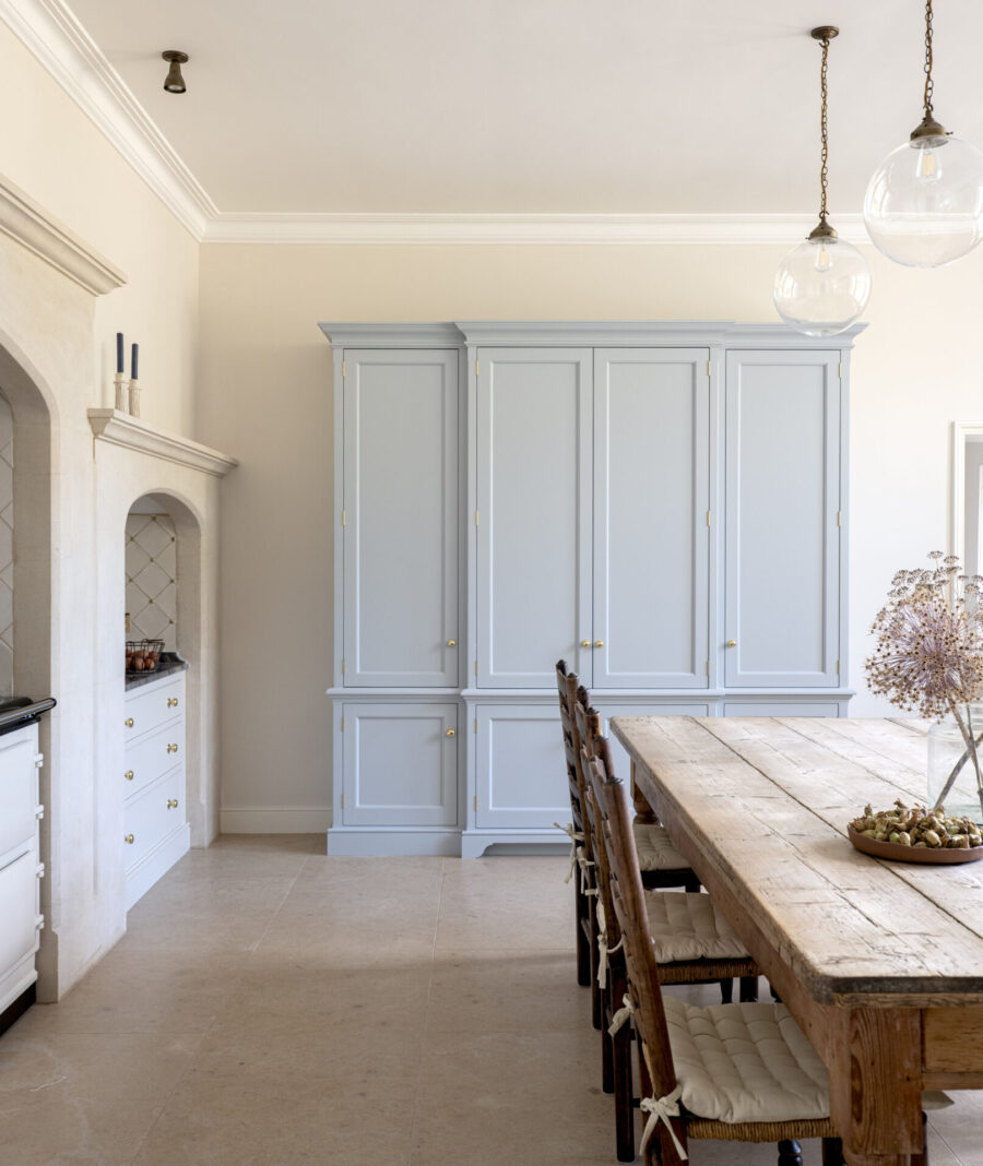A pale blue housekeeper's cupboard sits at the end of the room in a Kitchen for a Regency Villa