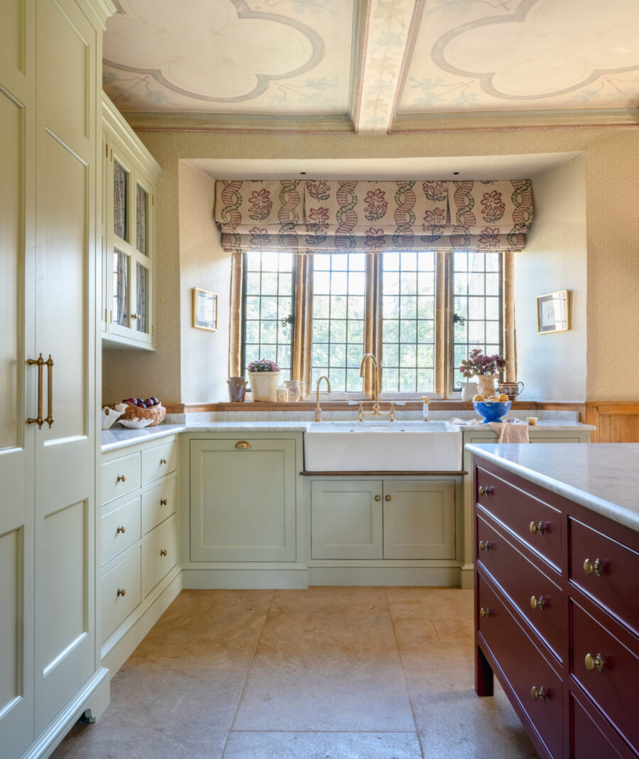 A handmade kitchen with Butler sink, glazed wall cabinets and large red kitchen island A handmade kitchen with Butler sink, glazed wall cabinets and large red kitchen island