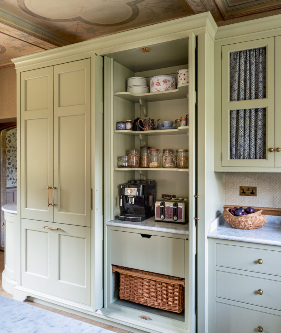 A larder cabinet with doors open revealing breakfast essentials. A larder cabinet with doors open revealing breakfast essentials.