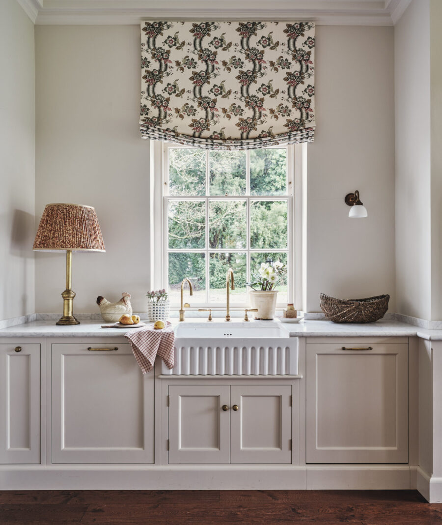 A fluted Butler's sink sits underneath a large sash window A fluted Butler's sink sits underneath a large sash window