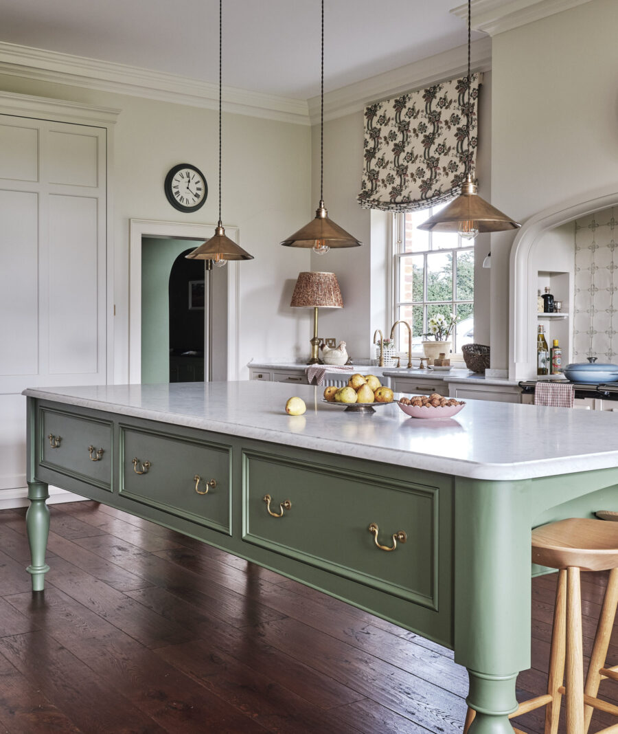 A green hand painted Cook's table kitchen island is central to this Edwardian country house kitchen design A green hand painted Cook's table kitchen island is central to this Edwardian country house kitchen design