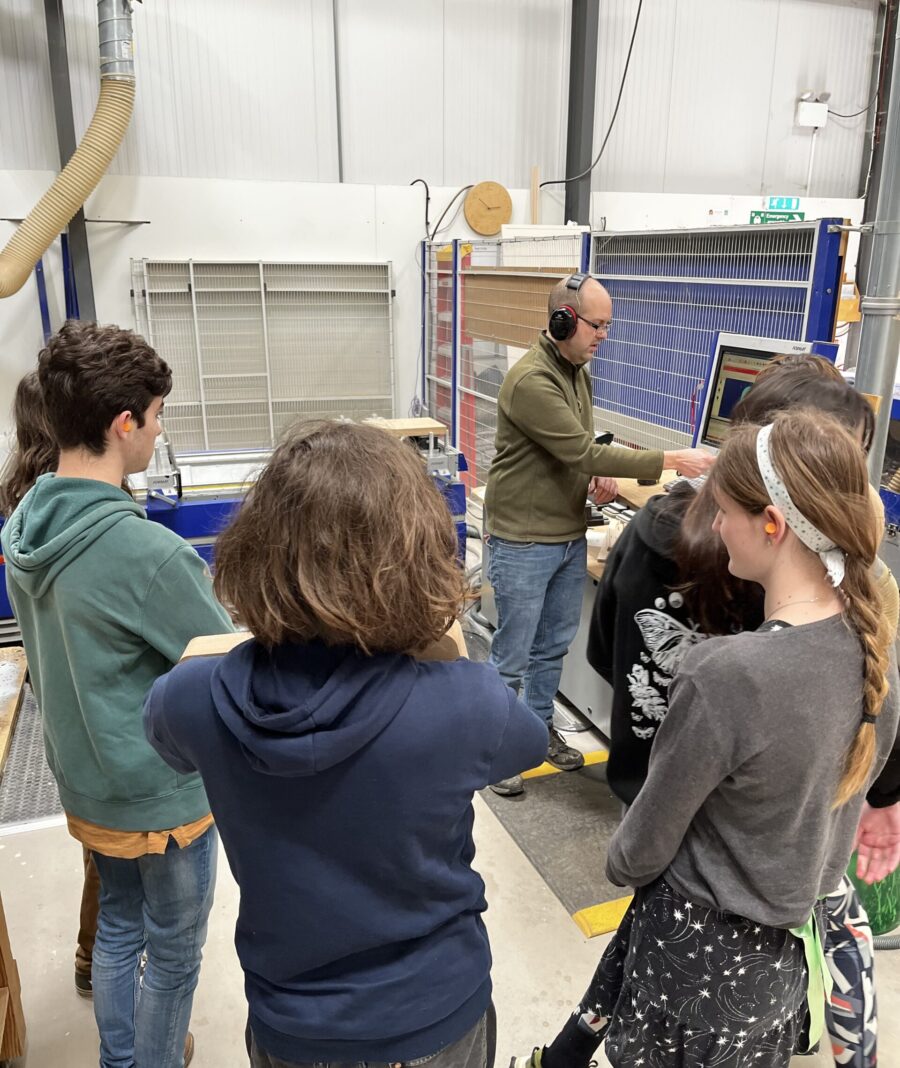 Students being shown how to use the CNC machine in the Guild Anderson workshop