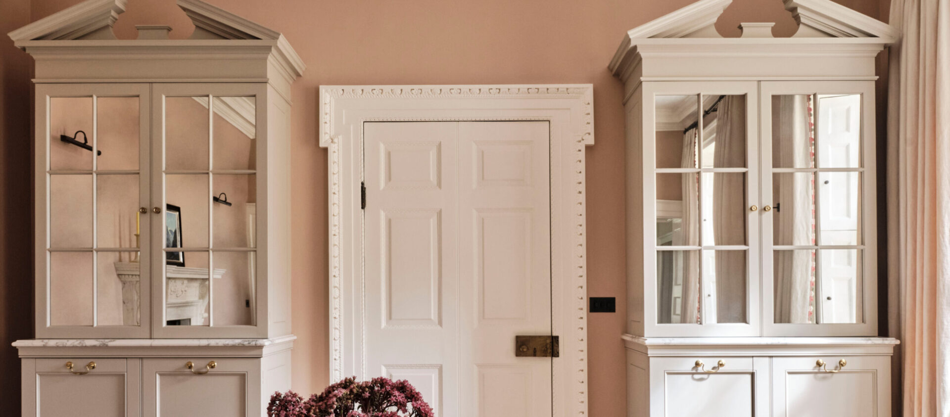 The Old Rectory dining room with classically proportioned tall bespoke mirror fronted cabinets