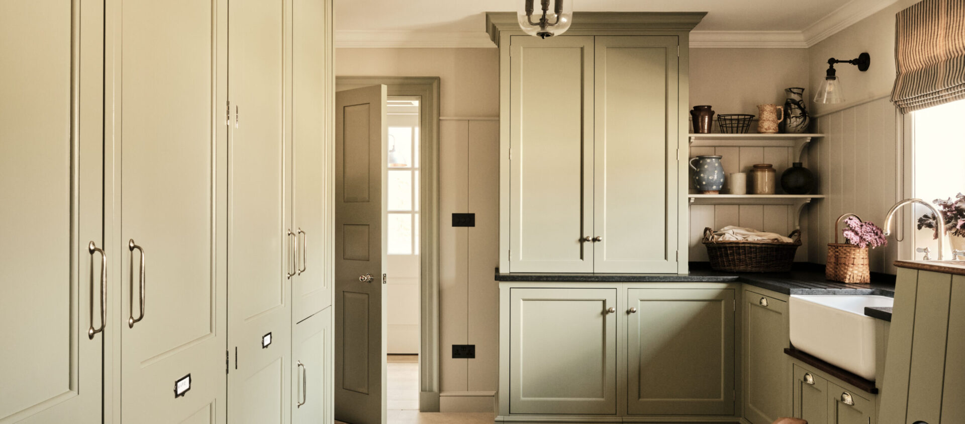 A bespoke green painted boot room and laundry in the Cotswolds