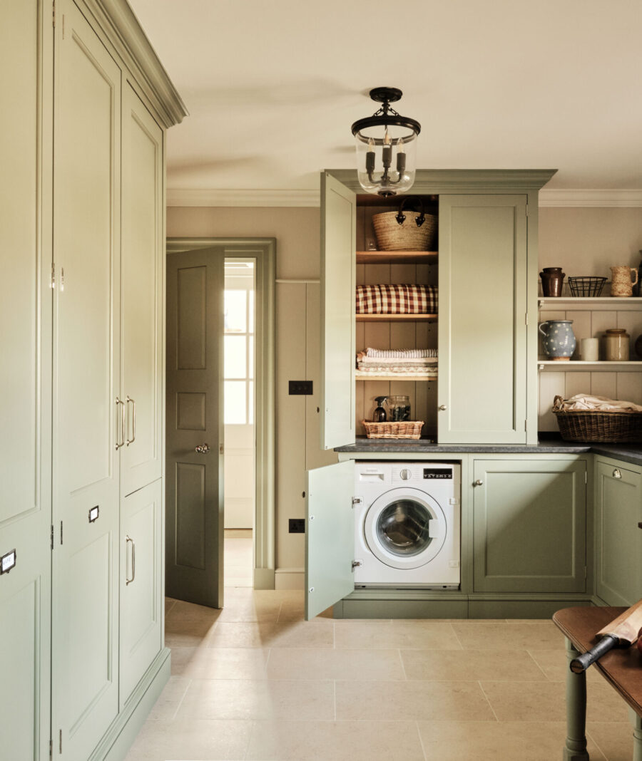 A multi functional utility room with hidden washing machine and a combination of storage options A multi functional utility room with hidden washing machine and a combination of storage options