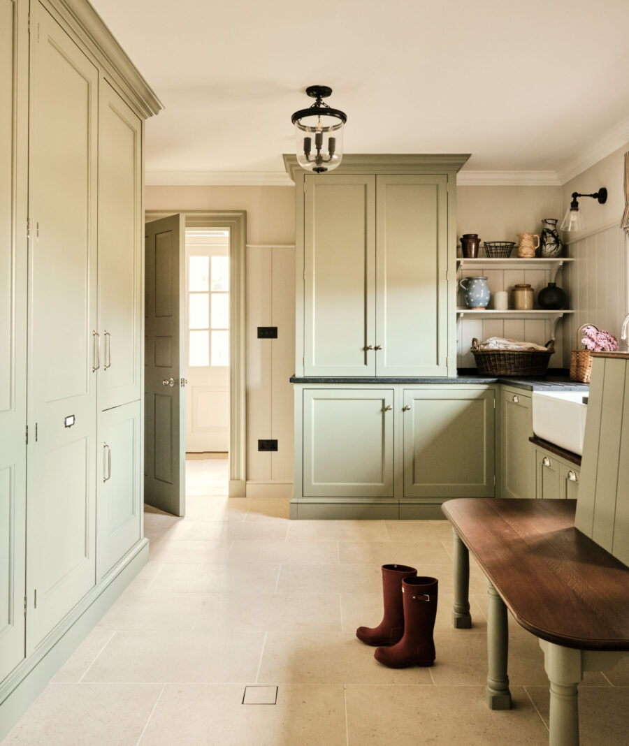 Tall cabinets and open shelves create a selection of storage options in this laundry area Tall cabinets and open shelves create a selection of storage options in this laundry area