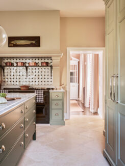 The Aga range cooker sits under a bespoke mantel piece that hides the extractor