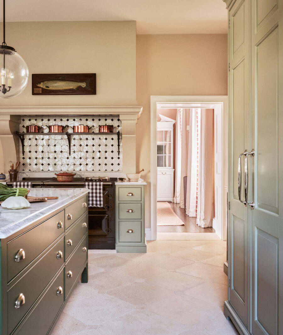 The Aga range cooker sits under a bespoke mantel piece that hides the extractor The Aga range cooker sits under a bespoke mantel piece that hides the extractor