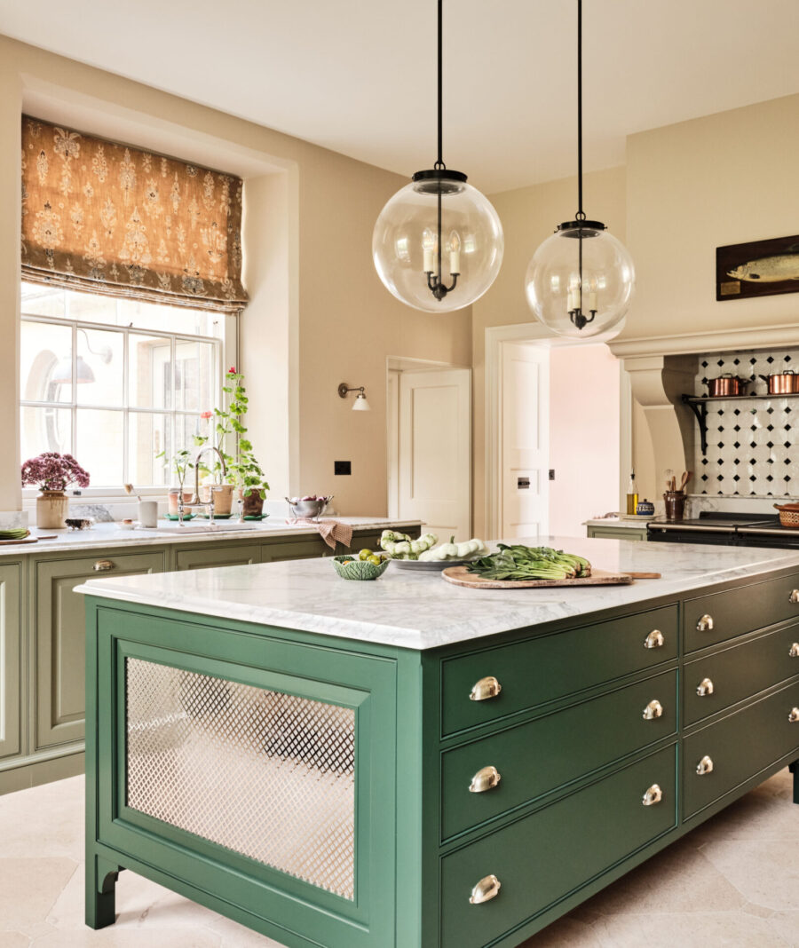 The Old Rectory period kitchen in the Cotswolds with green kitchen island with decorative grille feature and Aga range cooker The Old Rectory period kitchen in the Cotswolds with green kitchen island with decorative grille feature and Aga range cooker