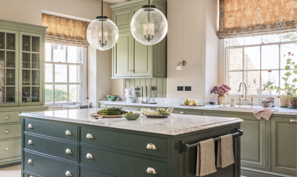 Bespoke green painted kitchen island with large Georgian sash windows